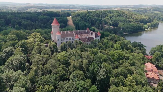 Drone flies close to Konopi&scaron;tě Castle, former residence of Archduke Franz Ferdinand of Austria, circling the grounds with the lake visible before moving closer along the exterior.