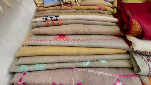 Stacked Embroidered Pashmina Shawls and Traditional Fabric Collection