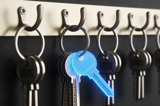Row of Metal Keys on Hook Board with One Glowing Blue