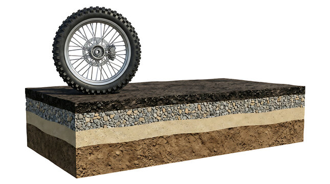 Heavy-duty tire on an exposed cross-section of road construction illustrating subsurface strata