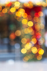 Warm yellow orange bokeh lights on dark blurred background. Abstract festive holiday texture. Soft defocused circles. New Year's background for greetings © Alla