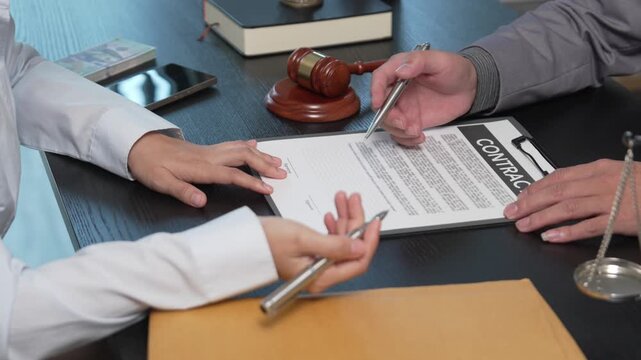 Female Client Submitting Case Files and Envelopes to Attorney During Legal Consultation in Law Firm