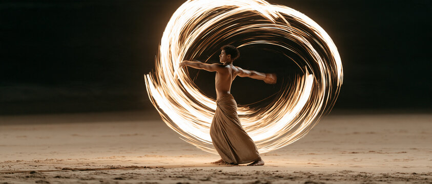 Woman Dancing with Glowing Fire Ring at Sunset