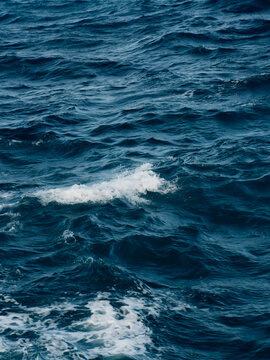 Dark blue sea texture with foamy wave patterns