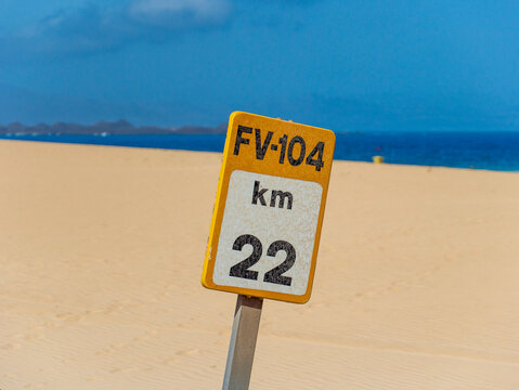 Fuerteventura road marker in a sandy desert landscape