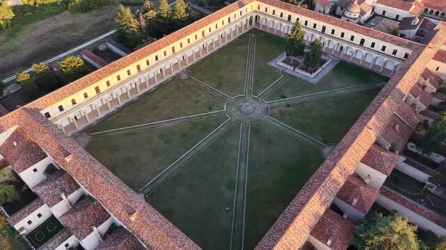 Aerial view over the arcades and lawn of the Great Cloister at the Charterhouse of Padula, a UNESCO World Heritage Site, Italy