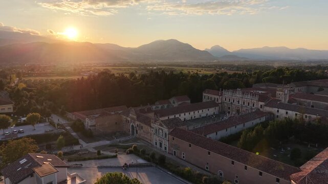 Sunset over the Vallo di Diano valley with the Certosa di Padula monastery and the Apennine mountains, Salerno, southern Italy