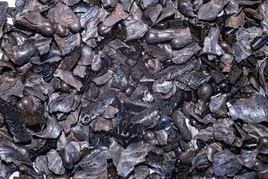 Detailed background texture of dark welding slag pieces metal scale residues and flux crust after electric arc welding process