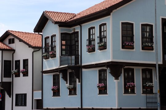 Close-up views of Konya houses restored a few years ago. Colorful flowers adorn the windows of these traditional Turkish houses. Konya, Turkey.