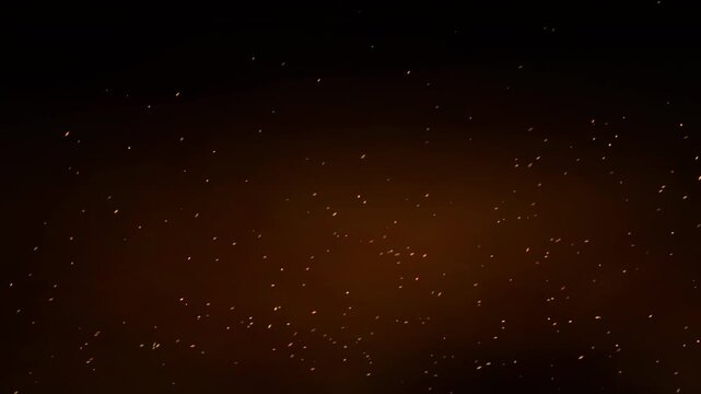 Seamless loop of sharp glowing fire sparks blown rapidly to the right and upwards, set against a thick, voluminous, bright orange smoky background.