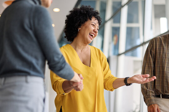 Group of  businesspeople having a meeting shaking hands handshake introducing each other and applauding during meeting in the office. Teamwork and success concept, portrait of a young businesswoman