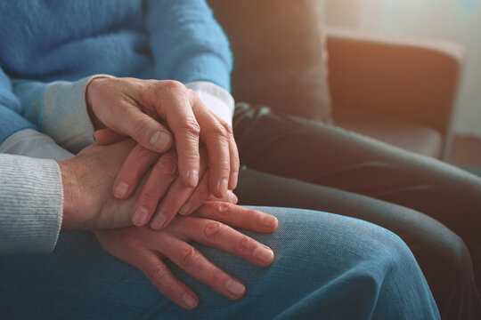 Close up of old people's hands keeping them together. Man has pu