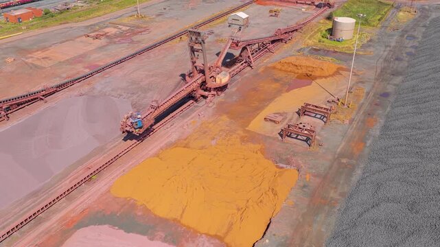 Industrial Stacker Reclaimer Moving Along Rails at a Large Ore Depot