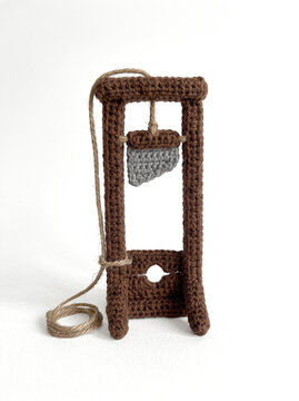 Crochet guillotine model on gray background