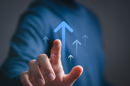 Business growth concept with a hand interacting with upward arrows, symbolizing progress, success, development, performance, digital transformation, strategic improvement, and increasing opportunities