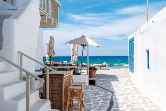 Charming alleyway lined with cafes in Naousa, Paros, Greece on a sunny day
