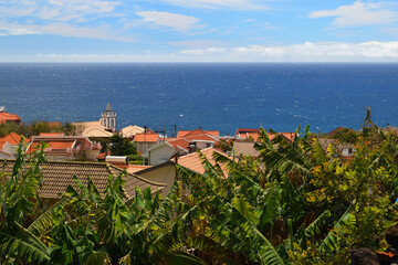 Coastal village with red tile roofs and banana plants overlooking the Atlantic Ocean, Madeira, Jardim do Mar © Gabor