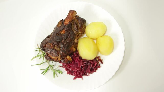 Roasted Pork Knuckle with Potatoes and Red Cabbage Top View