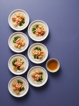 Vietnamese banh beo rice cakes in small white saucers on a purple background