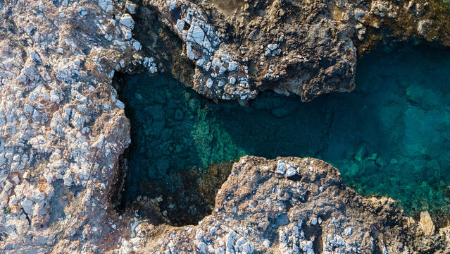 Stunning azure waters of Paros Greece contrasting with rocky coastline