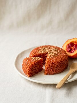 Vietnamese xoi gac red sticky rice with sesame seeds on a light cloth
