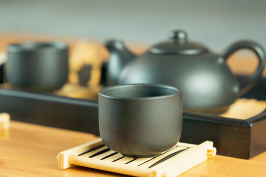 chinese tea ceremony gongfu tea set chahu teapot pinming cups on chaban tray, side view on wooden table with blurred background and copy space for banner design concept of tea culture, restaurant