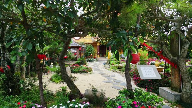 Static shot of garden with colorful flowers and stone path in peaceful backyard setting