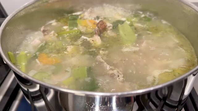 Chicken Carcass Simmering in a Pot for Homemade Stock
