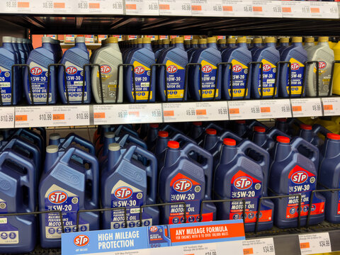 Aubrey, Texas, USA - September 22nd, 2026: STP synthetic motor oil bottles displaying on metal rack shelves with price tags inside AutoZone store