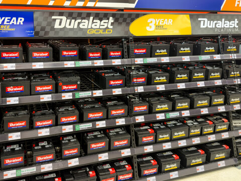 Aubrey, Texas, USA - September 22nd, 2026: Duralast Gold car batteries stacked inside AutoZone store