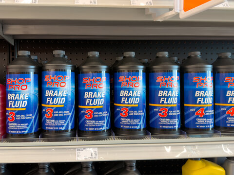 Aubrey, Texas, USA - September 22nd, 2026: Dark Shop Pro DOT 3 and DOT 4 brake fluid bottles standing inside AutoZone store