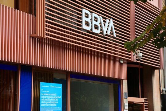 ALICANTE, SPAIN - APRIL 15, 2025: Person uses ATM at BBVA bank branch in Alicante, Spain. BBVA is one of largest banking groups in Spain.
