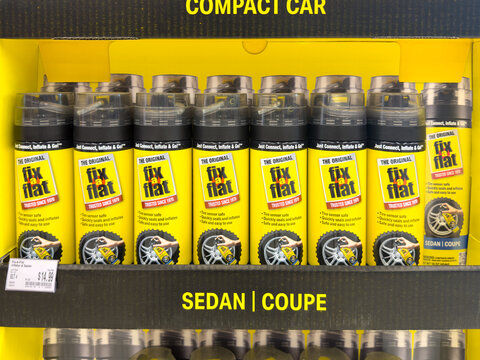 Aubrey, Texas, USA - September 22nd, 2026: Fix a Flat tire inflator cans stacked on retail display inside AutoZone store