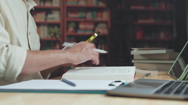Focused researcher conducts research with magnifying glass, expanding academic research careful document investigation.