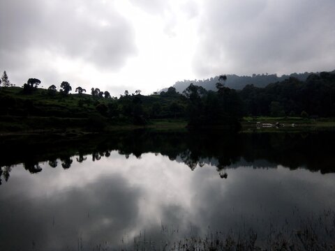 situ patenggang lake with trees and the sky reflection