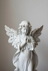 Fototapeta premium Spirituality and faith concept white marble angel statue with praying hands and wings religious peace and hope serene cherub sculpture for memorial