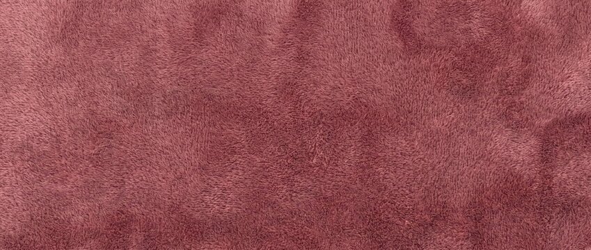 Dusty rose velour fabric texture background. Soft plush velvet cloth surface. Warm fleece textile closeup