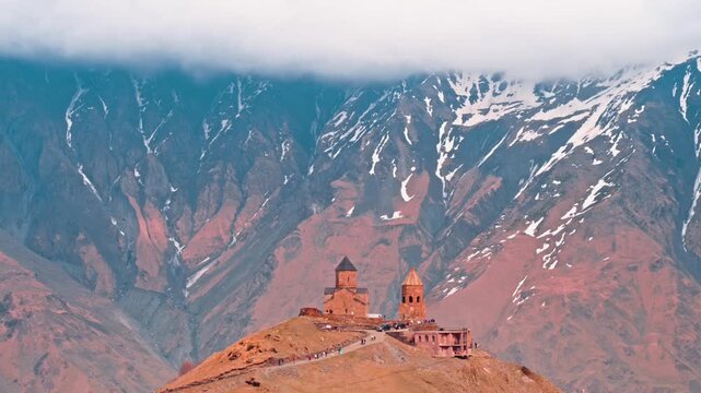 Gergeti trinity church against the backdrop of the caucasus mountains in georgia