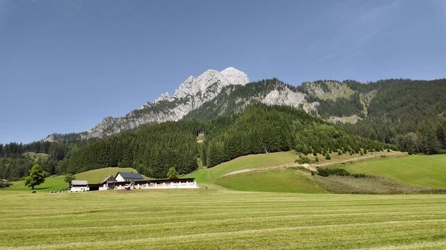 Solitary houses in a meadow with dramatic Ges&auml;use mountain backdrop