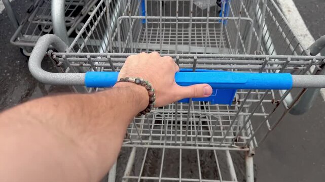 Point of view shot of person pulling shopping cart from cart return