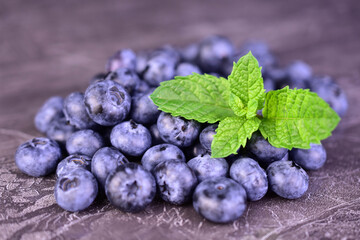 Fresh blueberries on a black marbled background. Close-up.  © Olivka888