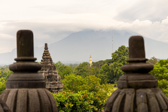 Prambanan Temple in Central Java, Indonesia. A vast 9th-century Hindu temple complex with intricate stone spires, sculptures, and ancient ruins under a cloudy sky.