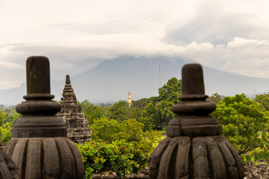 Prambanan Temple in Central Java, Indonesia. A vast 9th-century Hindu temple complex with intricate stone spires, sculptures, and ancient ruins under a cloudy sky.