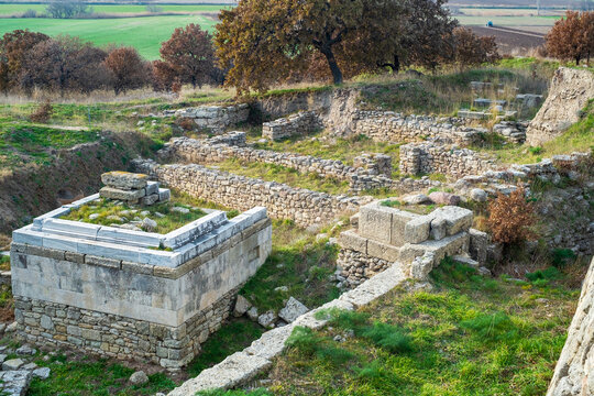 Excavated marble altar and stone wall foundations at the UNESCO site of ancient Troy, historic Ilion of Homer epic Iliad and the Trojan War between Achaeans and Trojans.