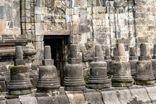 Prambanan Temple in Central Java, Indonesia. A vast 9th-century Hindu temple complex with intricate stone spires, sculptures, and ancient ruins under a cloudy sky.