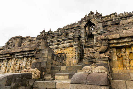 Ancient stone stupas of Borobudur, a UNESCO World Heritage Buddhist monument in Central Java, Indonesia, under an overcast sky.
