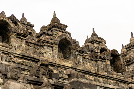 Ancient stone stupas of Borobudur, a UNESCO World Heritage Buddhist monument in Central Java, Indonesia, under an overcast sky.