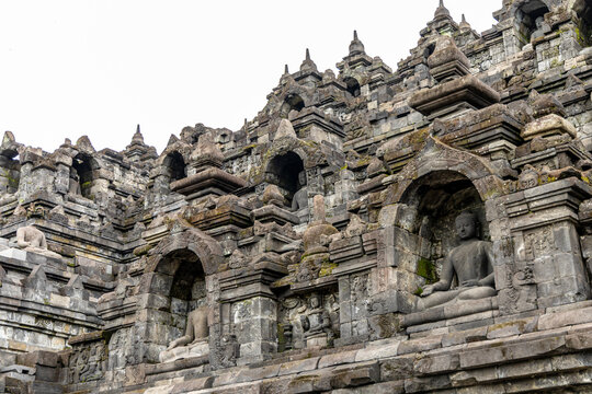Ancient stone stupas of Borobudur, a UNESCO World Heritage Buddhist monument in Central Java, Indonesia, under an overcast sky.