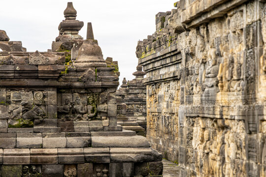 Ancient stone stupas of Borobudur, a UNESCO World Heritage Buddhist monument in Central Java, Indonesia, under an overcast sky.