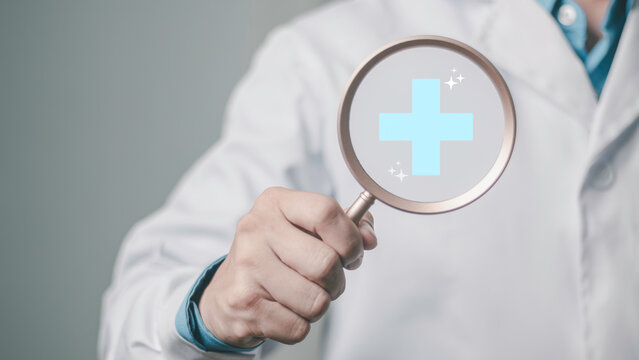 Claim review, healthcare verification, performance, and patient protection. Medical insurance search concept showing a doctor using a magnifying glass with a blue medical symbol, plus icon.